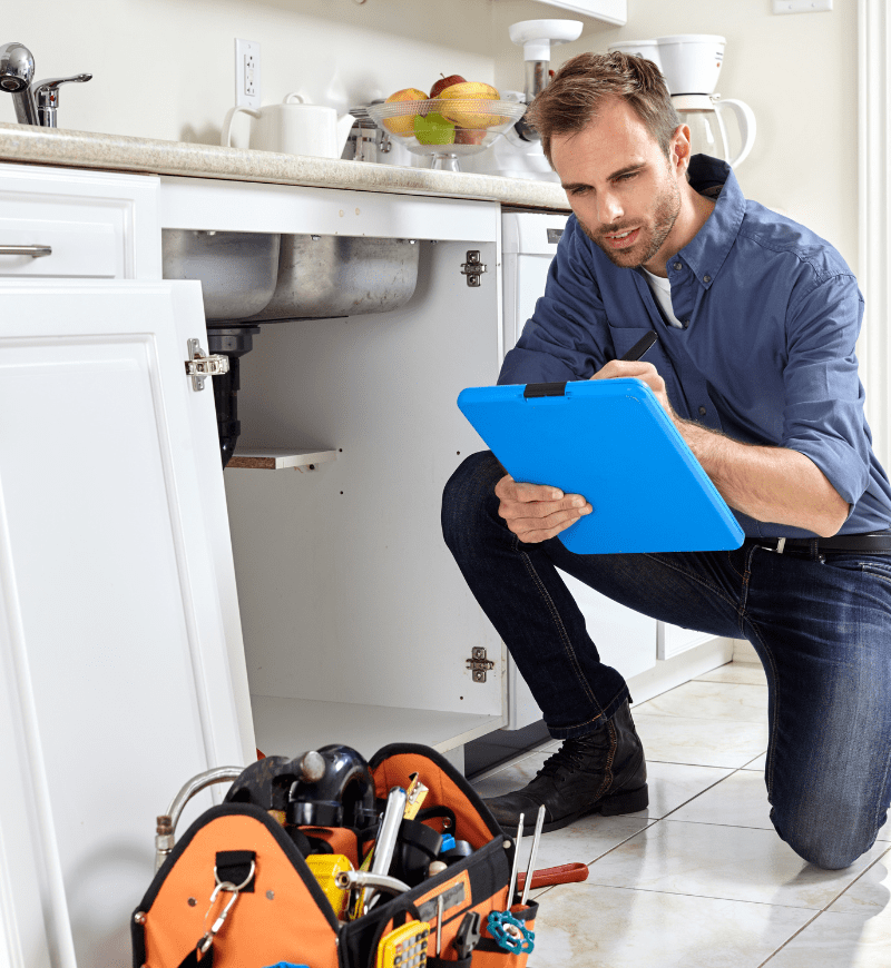 Plumber checking paperwork on a clipboard
